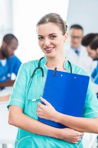 Healthcare professional holding a clipboard in a clinical training setting