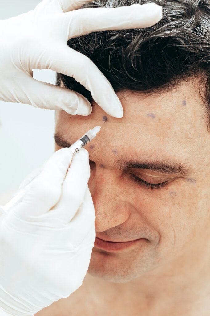 Cosmetologist conducts rejuvenation procedure puts injection on man, rejuvenating treatments